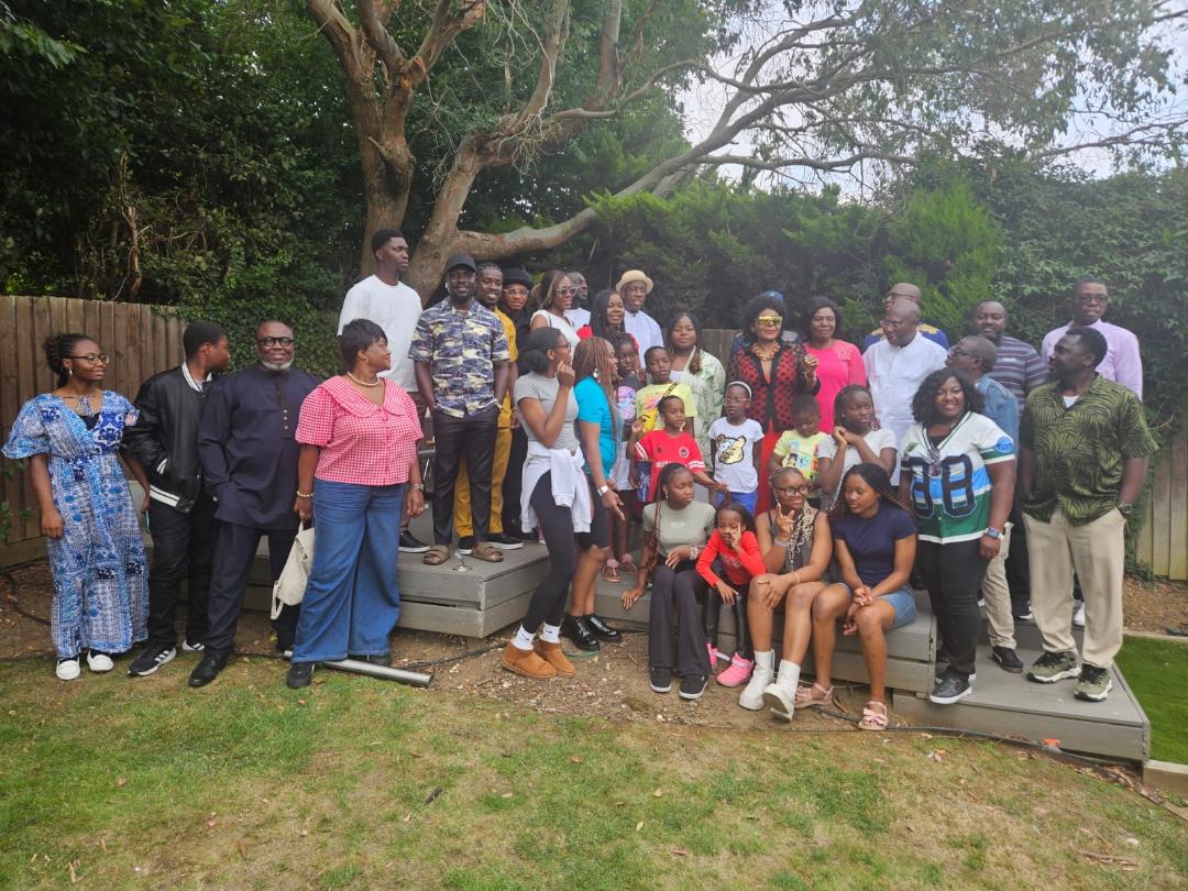 Group photograph of Ogbia Community UK members and families gathered in a garden at the 2025 summer barbecue