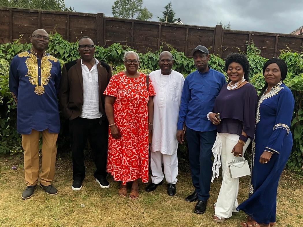 Elders of the Ogbia Community UK standing together in a garden, several in traditional attire